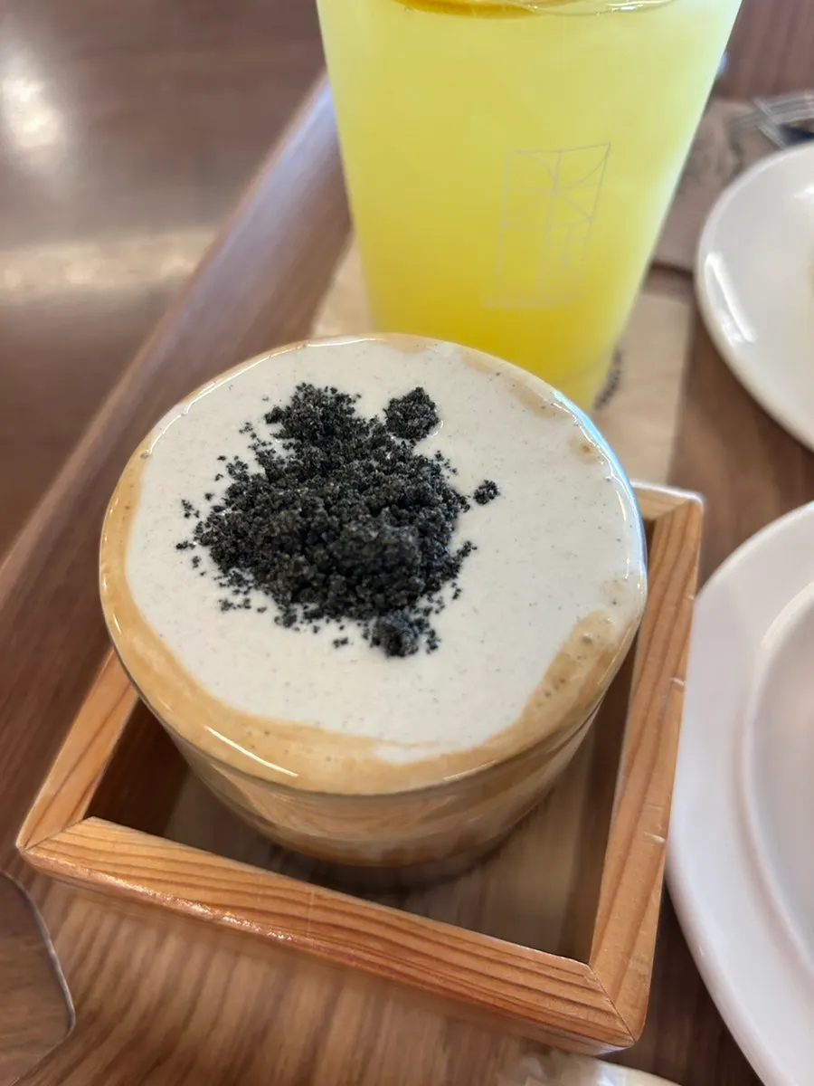 MIMI cream latte topped with black sesame garnish