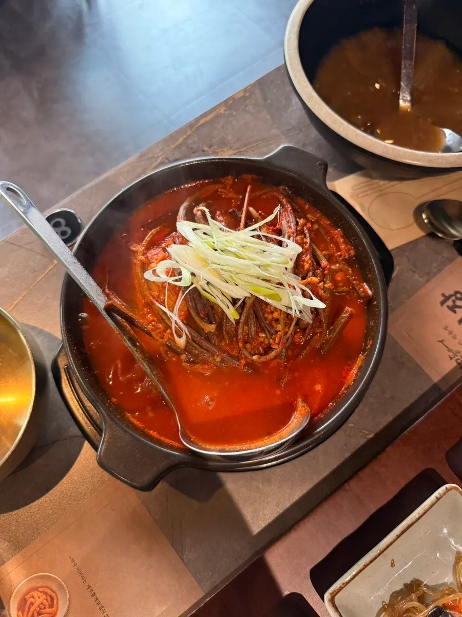 Spicy pork served alongside grilled mackerel