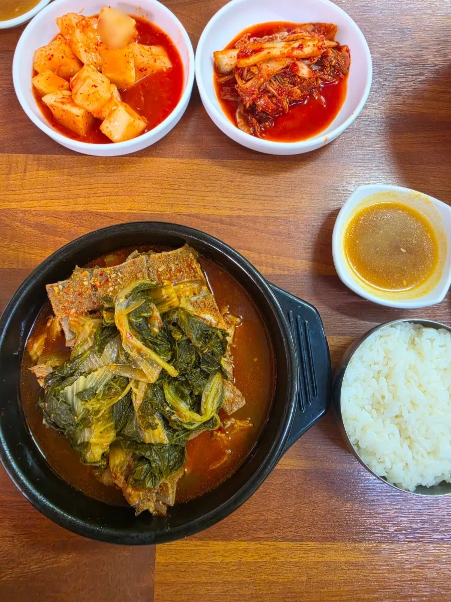 A spoonful of pork bone soup meat over rice