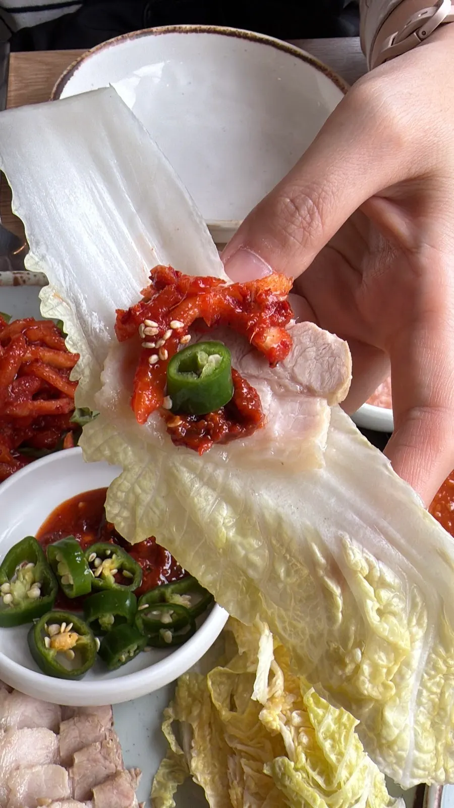 Kimchi, lettuce, and julienned radish served with bossam