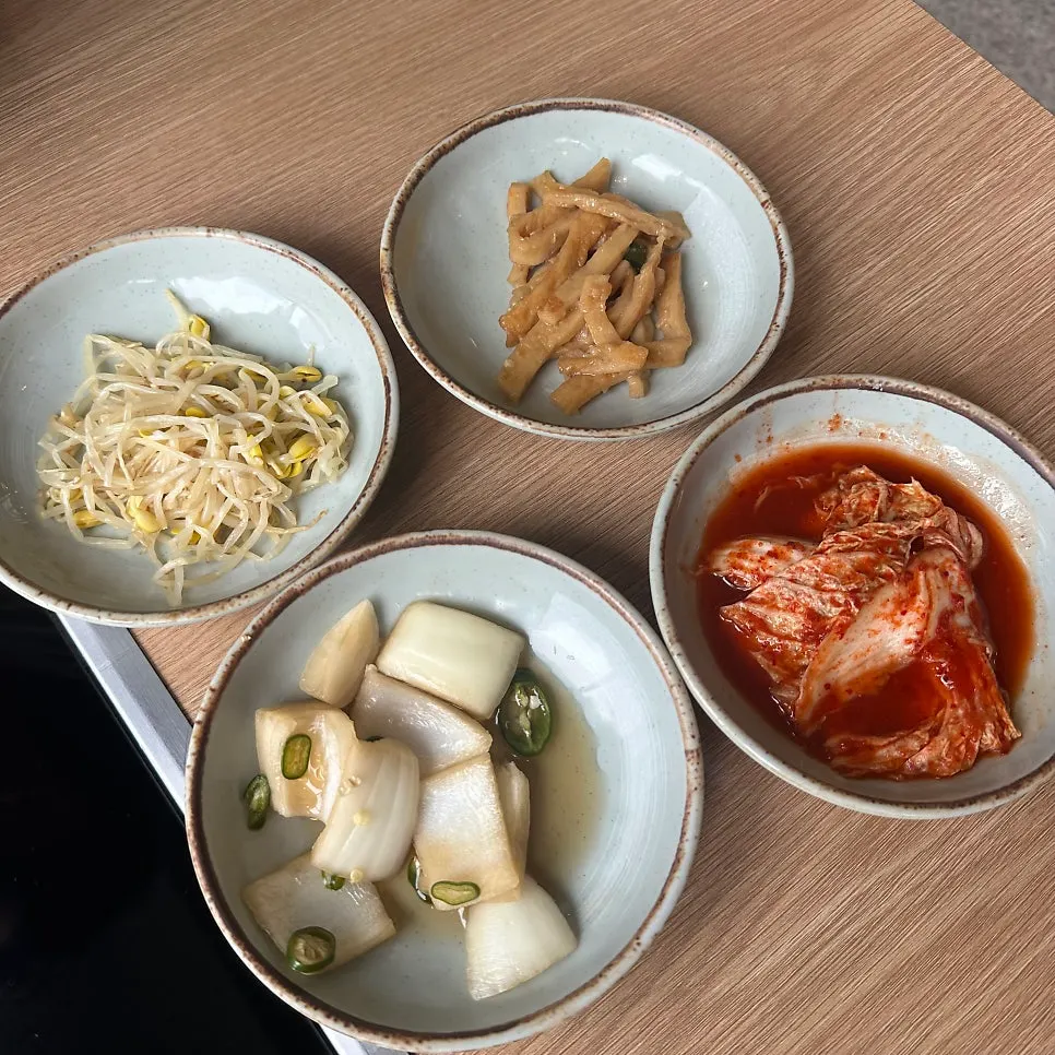 Four basic side dishes including seasoned bean sprouts and stir-fried fish cake