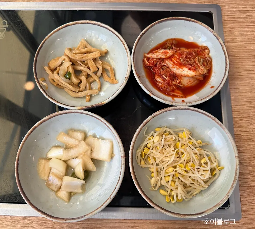 Basic side dishes set out after ordering the spicy kalguksu and mini bossam