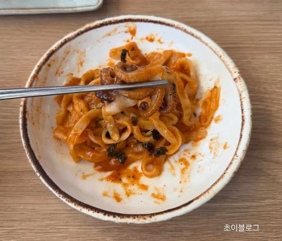 A bite of kalguksu noodles topped with octopus