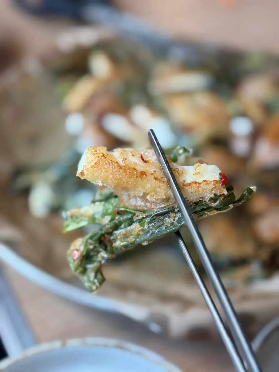 A piece of the seafood pancake lifted from the plate