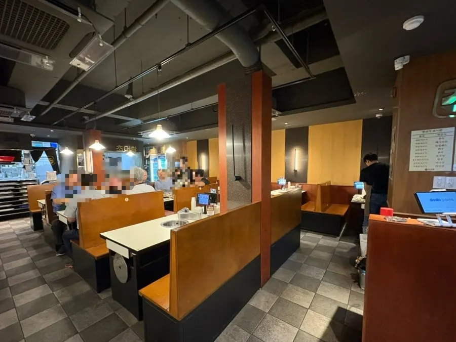 Dining hall at Chodaechang Dangsan Station with widely spaced tables