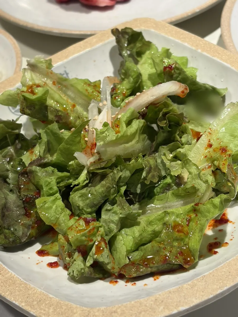 Korean beef gopchang served with vegetable skewers
