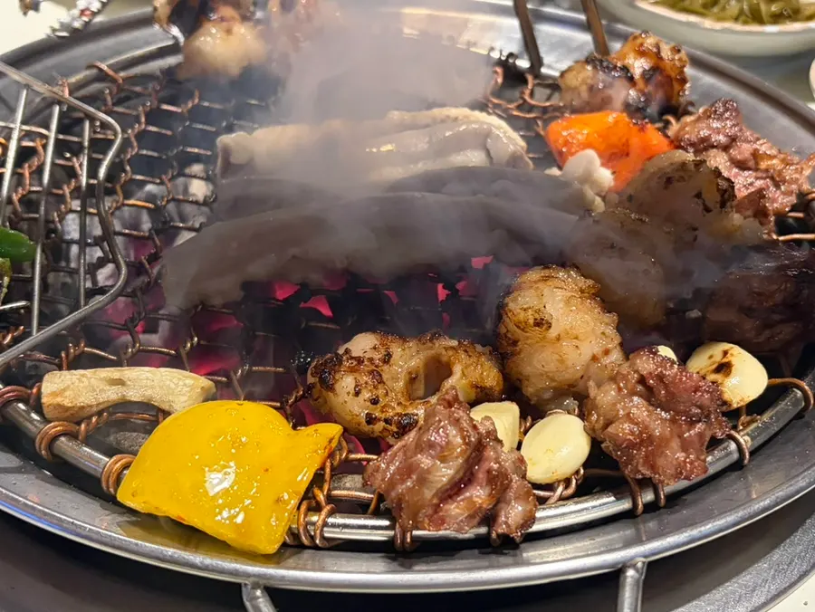 Well-cooked galbisal dipped in its dedicated sauce
