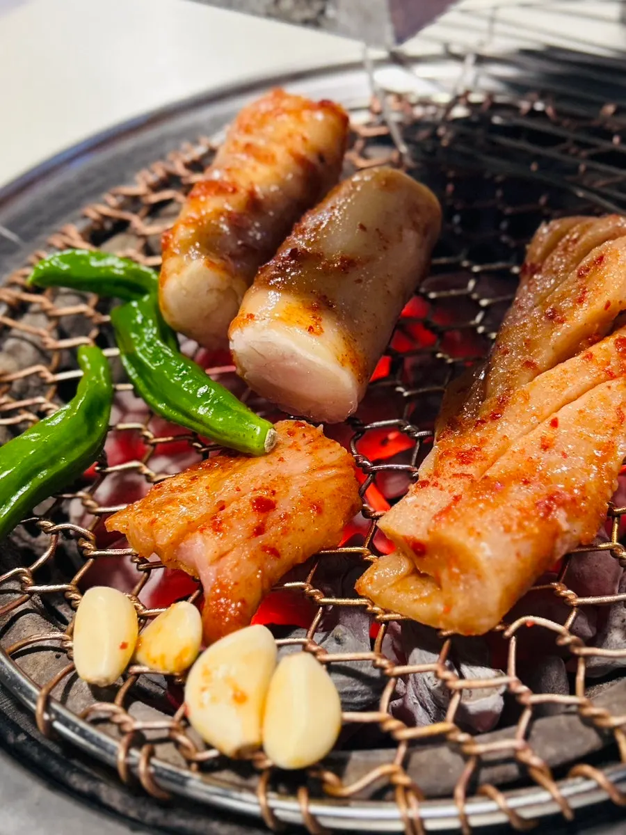 Staff grilling daechang tableside