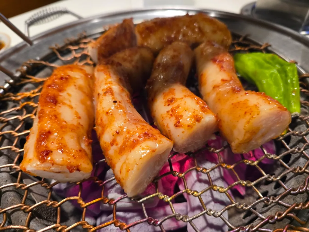 Seasoned daechang starting to grill on the pan