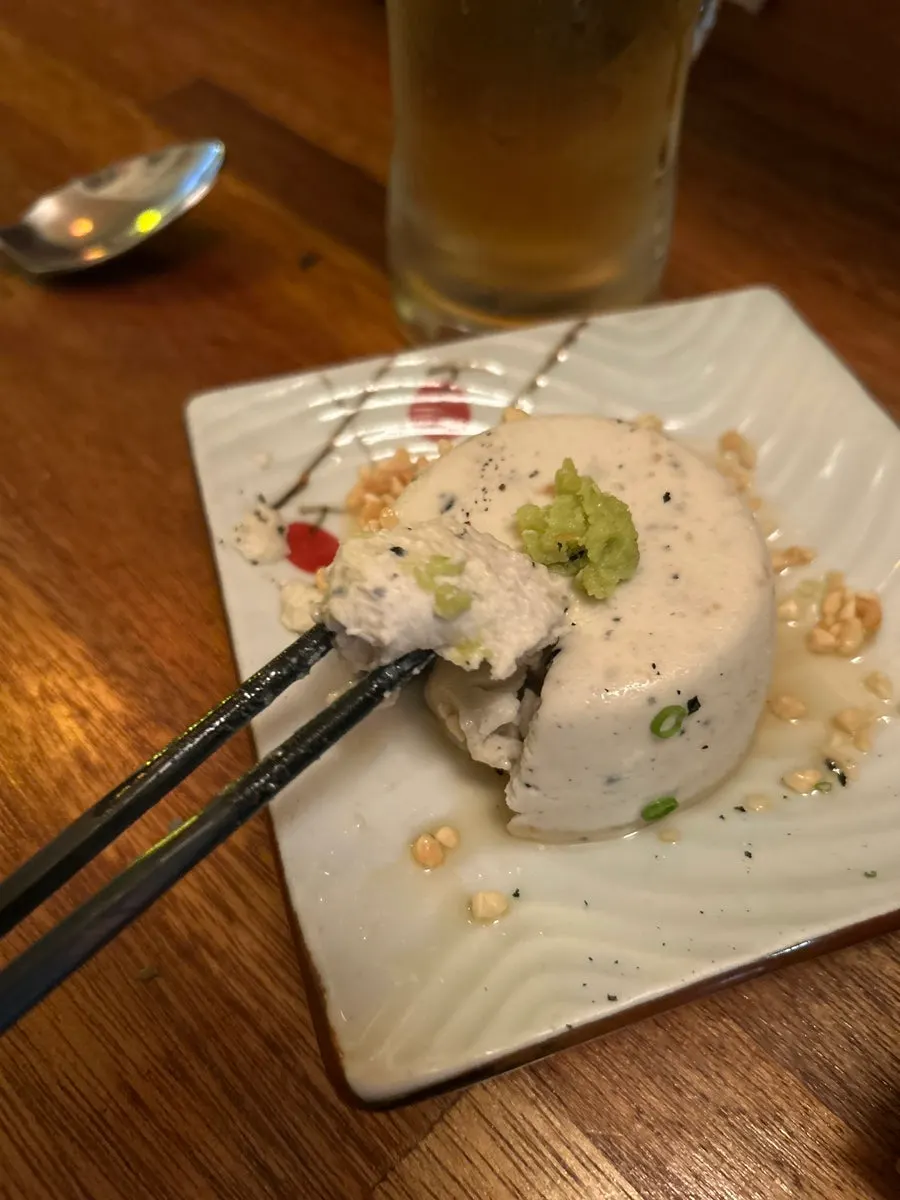 A plate of handmade black sesame mochi tofu