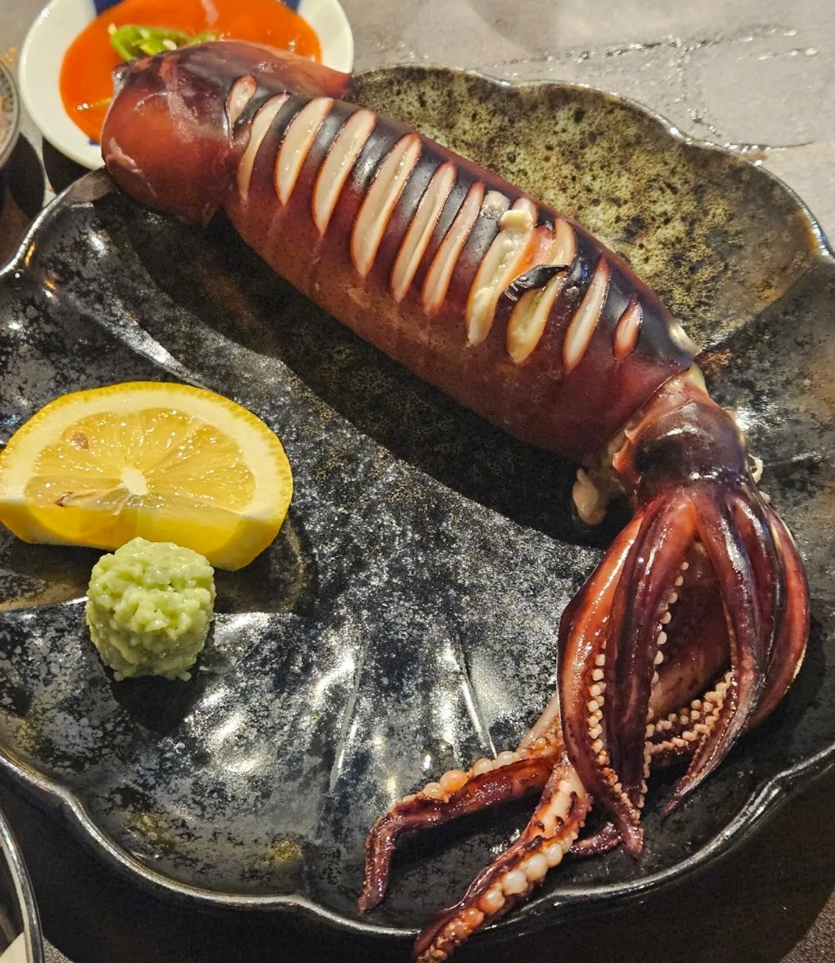 Table at Kaken with steamed squid and skewers