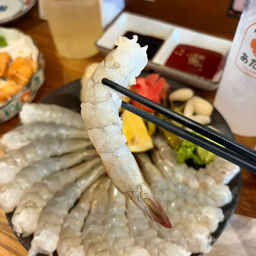 Close-up of a large piece of raw shrimp sashimi