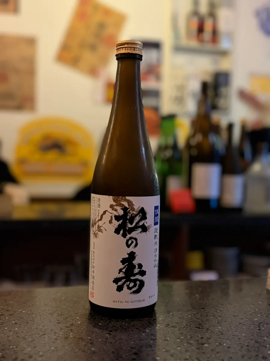 Sake being poured into a tokkuri flask