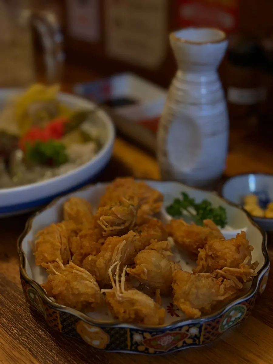 Fried shrimp heads served alongside sake