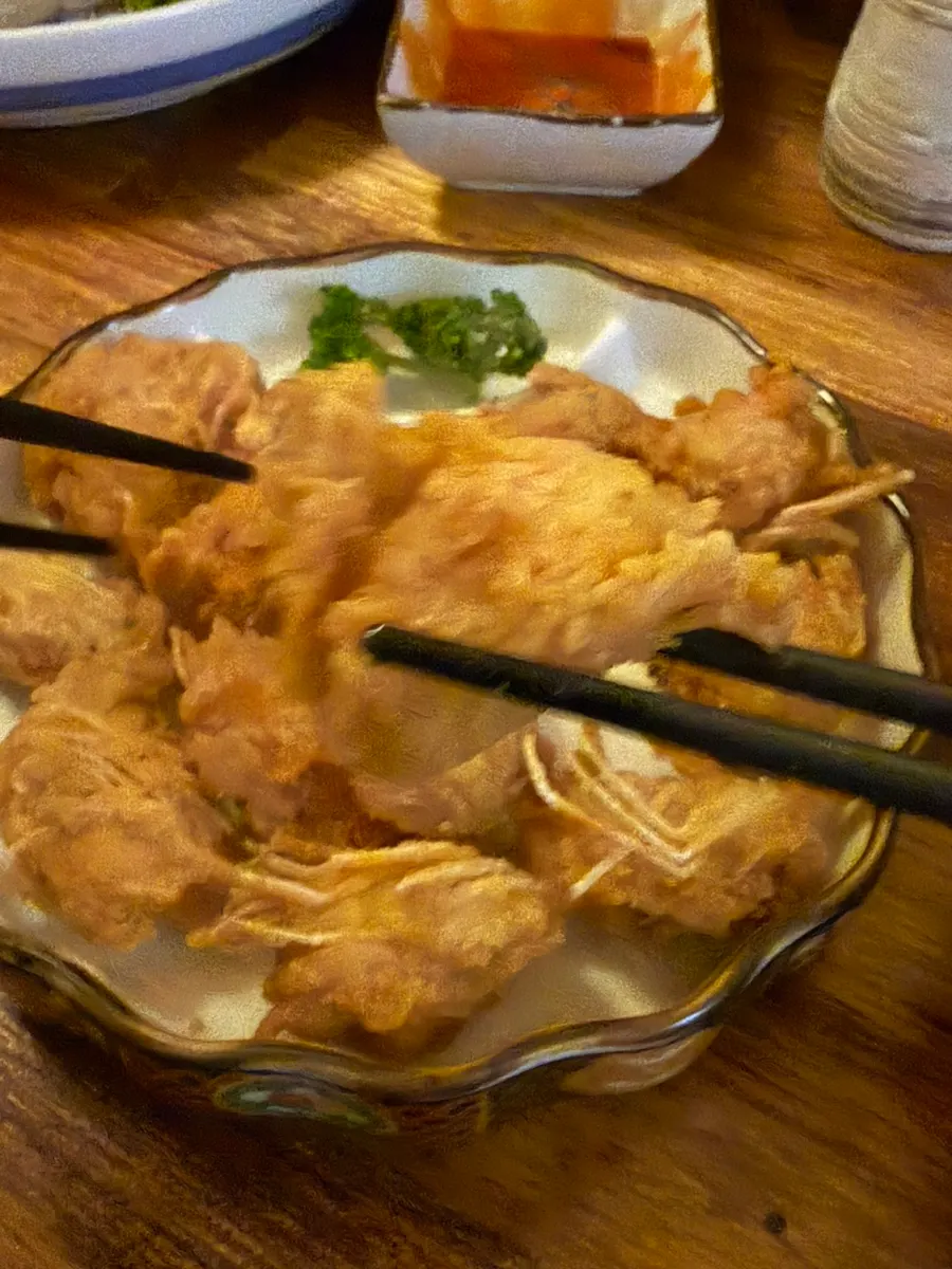 A table enjoying raw shrimp sashimi with sake