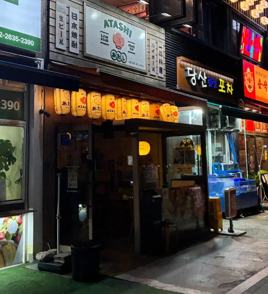 밤에 은은하게 불이 켜진 아타시 간판