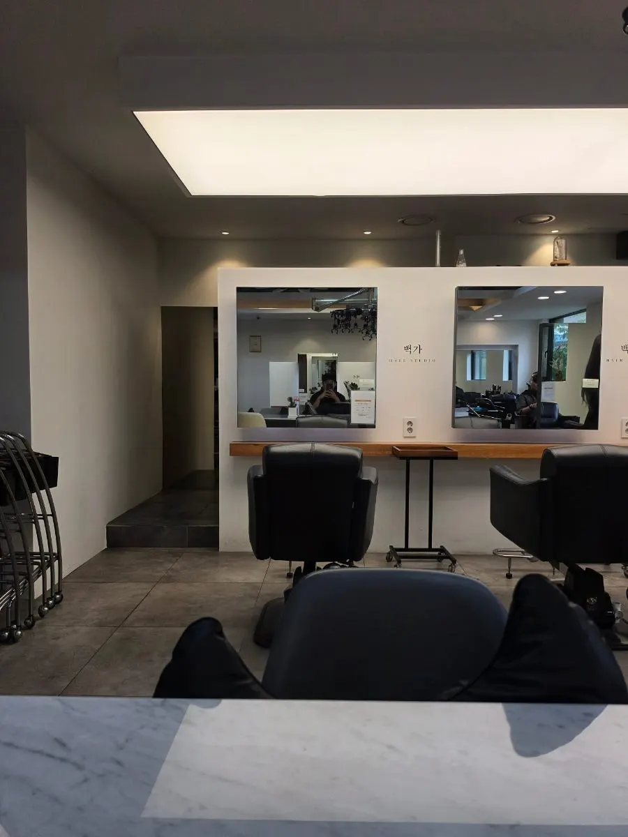 White-toned waiting area inside the hair salon