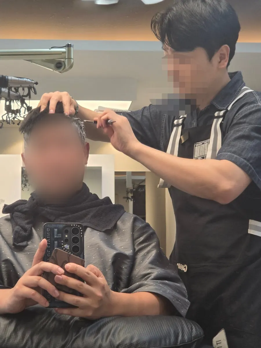 Seated and prepped for the men's down perm