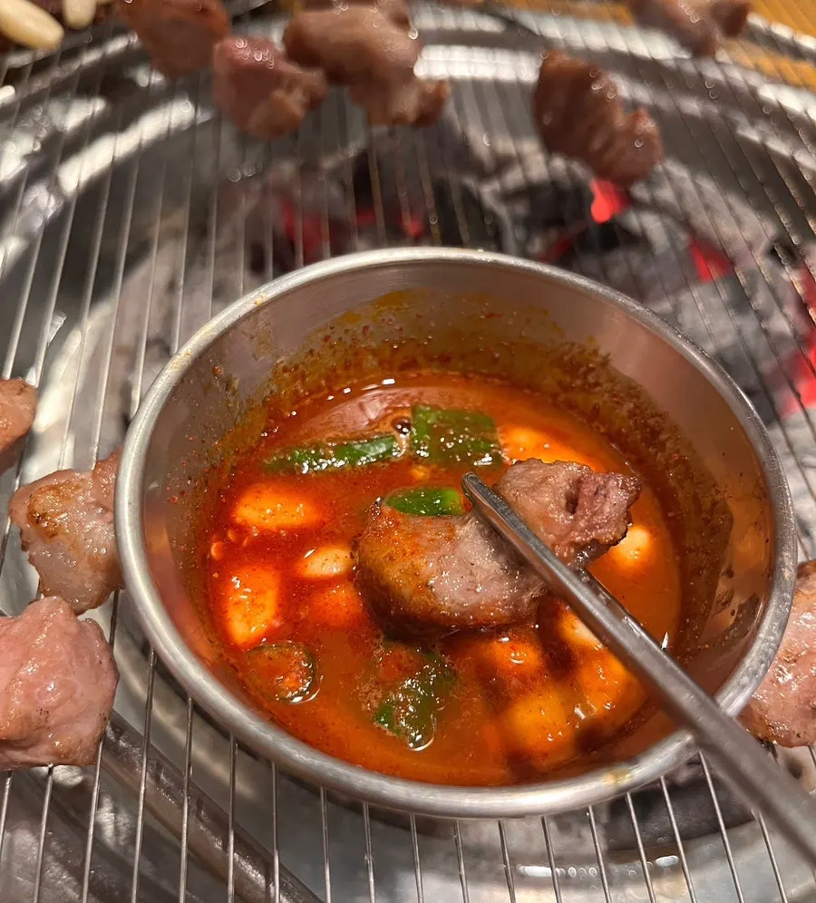 Meat dipped into bubbling gulchi sokjeot