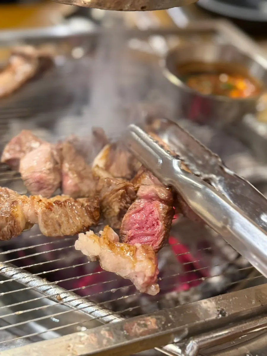 A bite of lamb rib with lettuce wrap