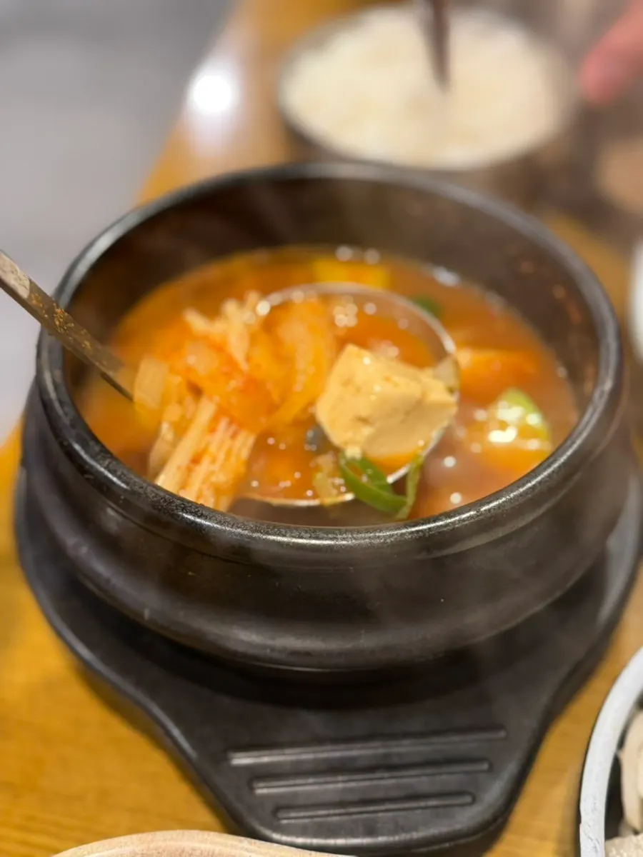 Mussel doenjang jjigae broth and rice table setting