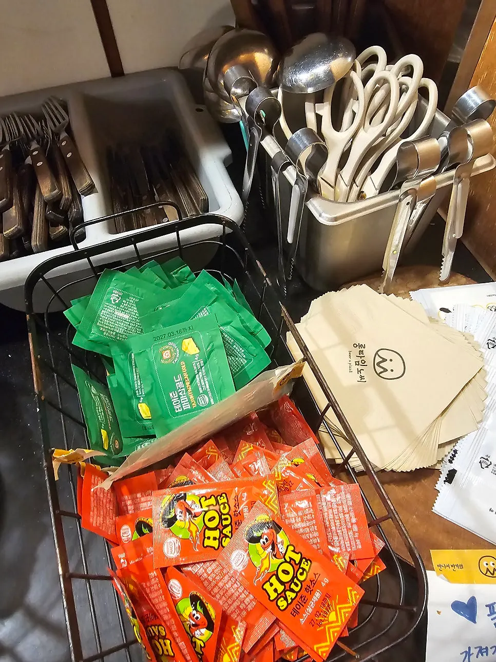 Self-service zone with cheese powder and hot sauce
