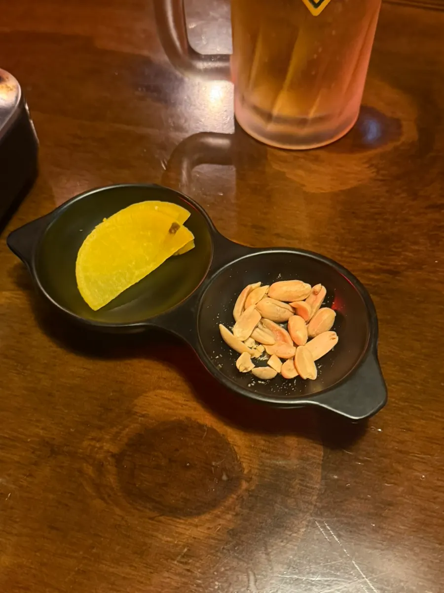 Complimentary peanuts and pickled radish