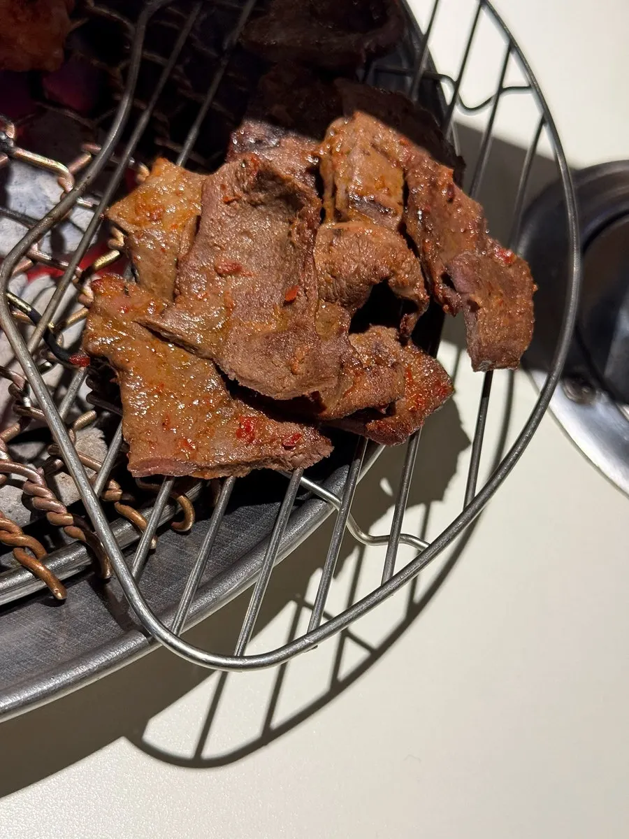 Staff charcoal-grilling the food