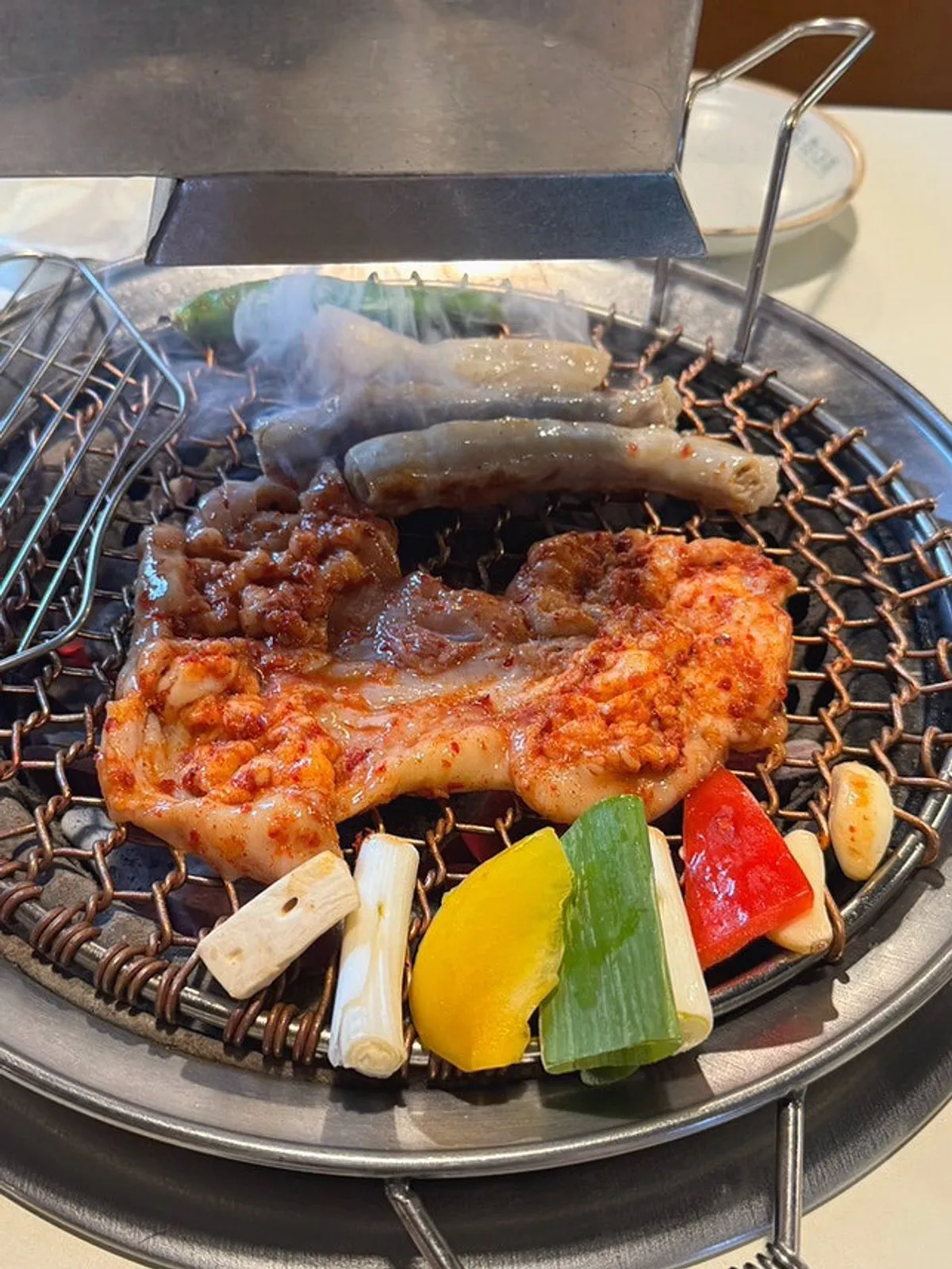 Hanwoo gopchang-gui grilling over charcoal