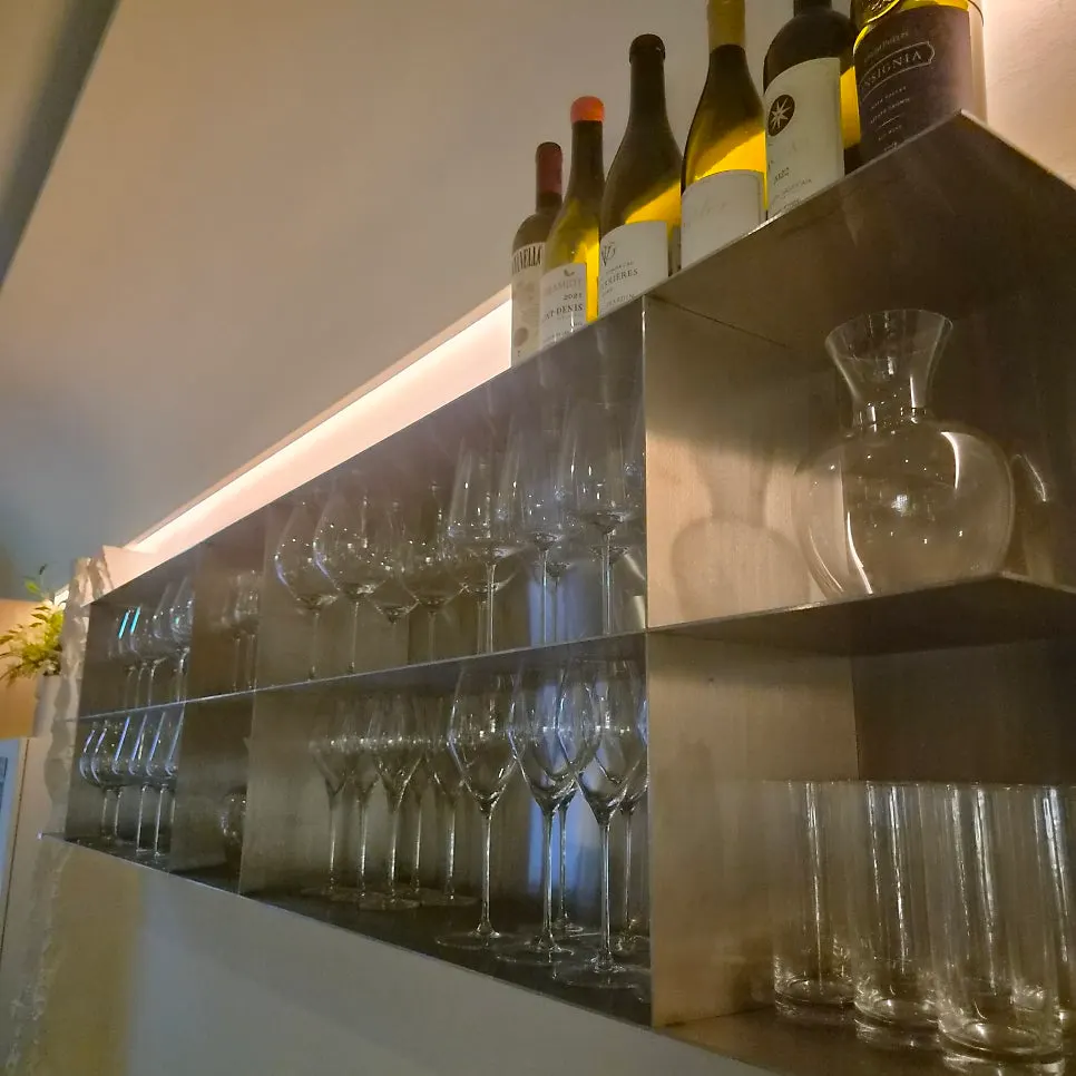 Wine bottles and glasses displayed at the wine bar