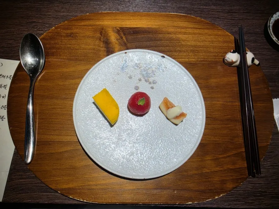 Appetizers of fig, marinated tomato, and an egg dish