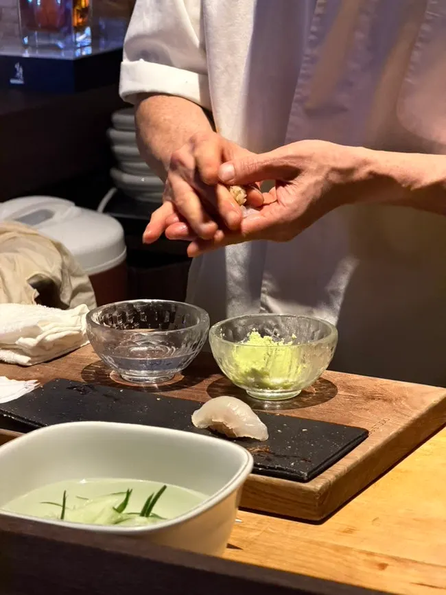 Sashimi plate topped with a cucumber crane garnish