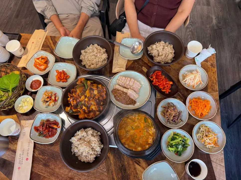 Table set with jeyuk, bossam, barley rice, and doenjang jjigae