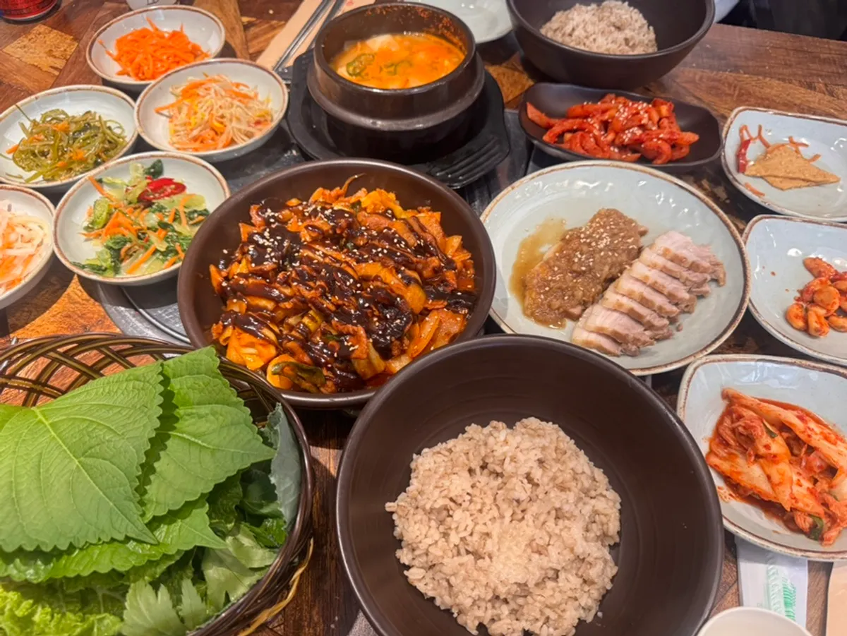 Full spread of the jeyuk barley rice set and black garlic suyuk