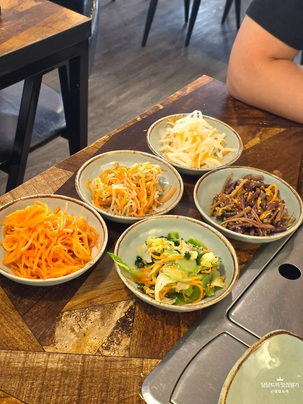 Side dishes, namul, and barley rice served first at the table