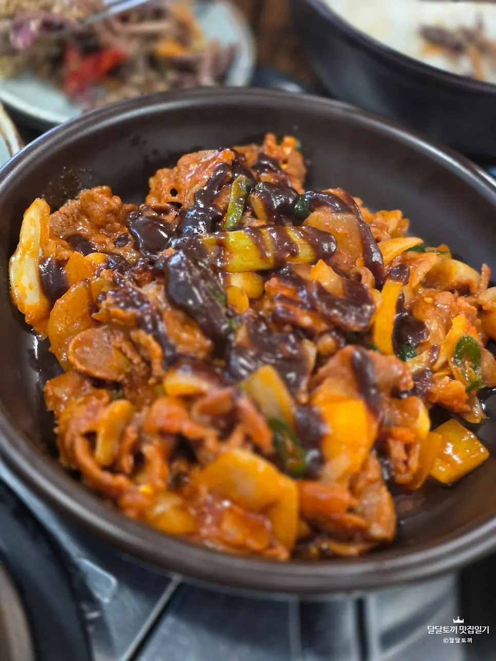 Plate of black garlic jeyuk stir-fry with seasoning soaked in