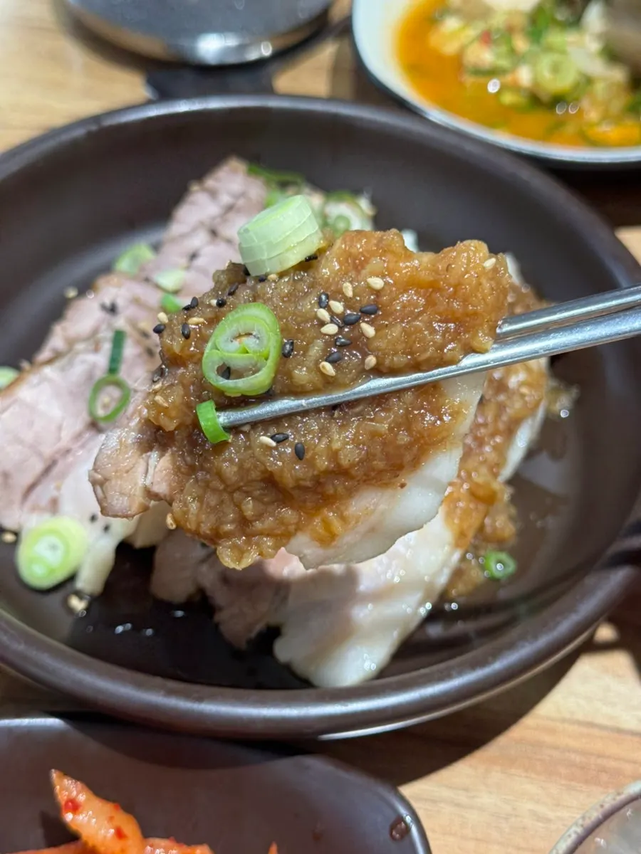 흑마늘 소스가 올라간 수육 접시