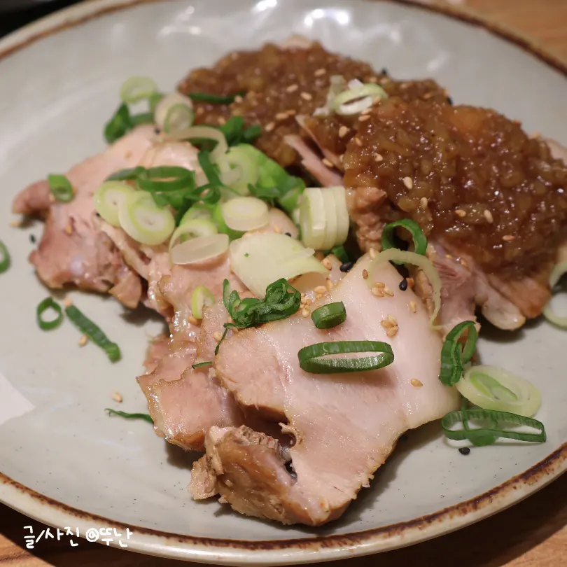 A plate of braised pork topped with black garlic sauce