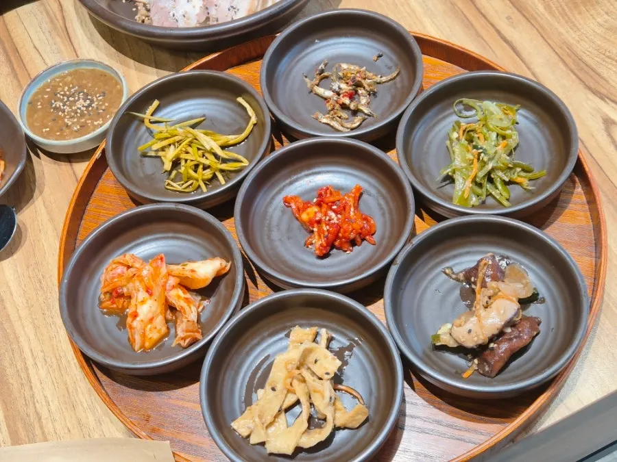 Full table setting of black garlic pork ssambap