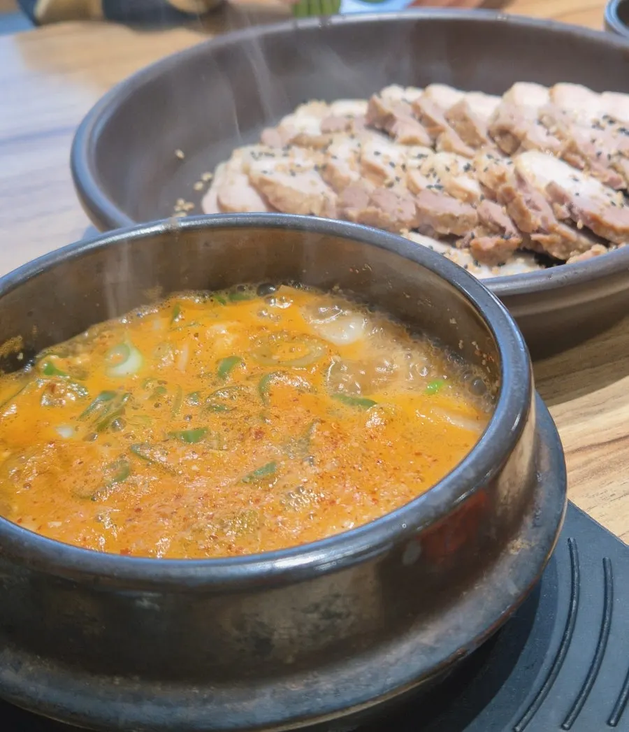 Family lunch table of black garlic pork ssambap