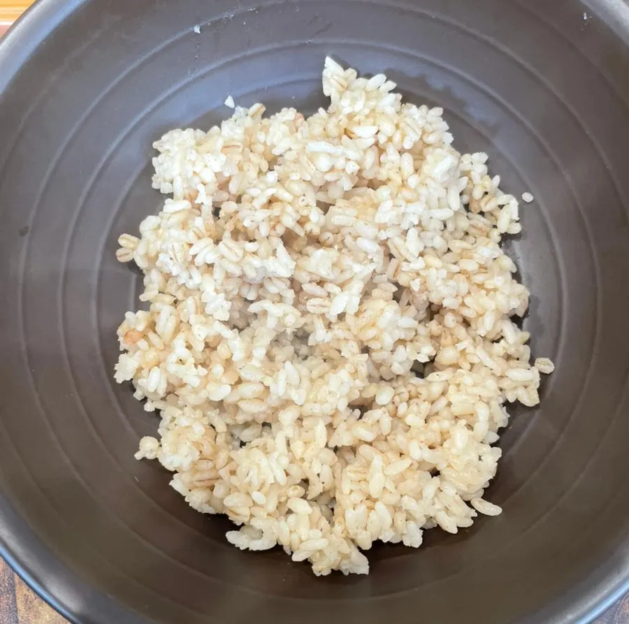 Bowl of black garlic barley rice served first