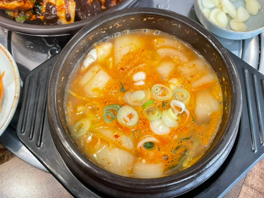 Full table set for two with jeyuk and side dishes
