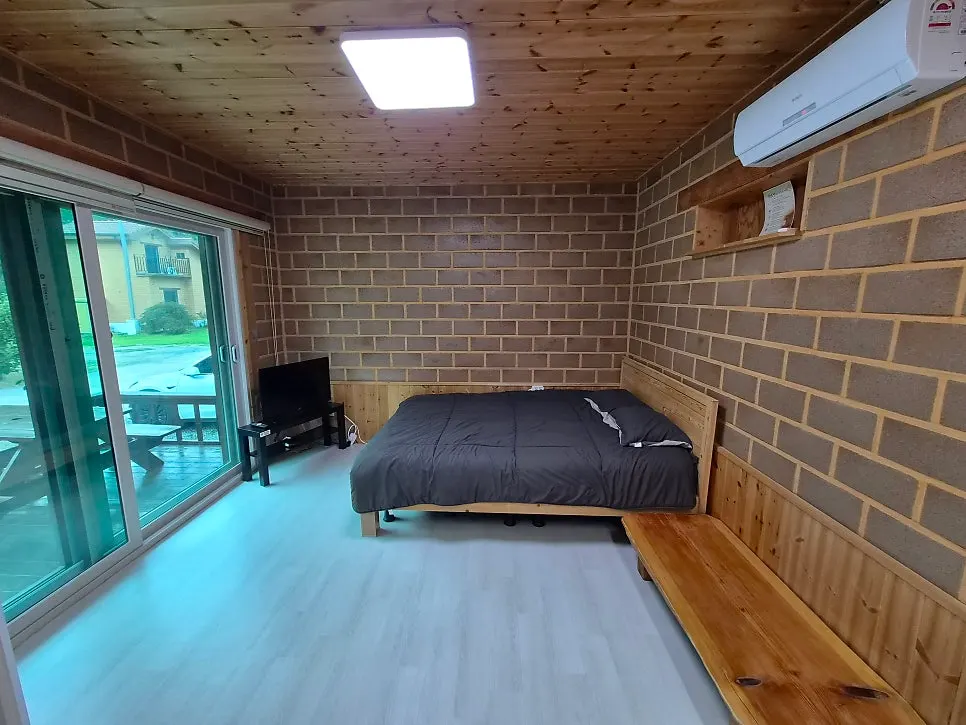 Room with ocher brick-patterned walls and wood interior