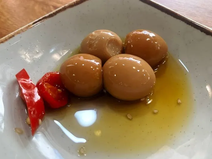 Napa cabbage kimchi, seasoned garlic, and quail eggs