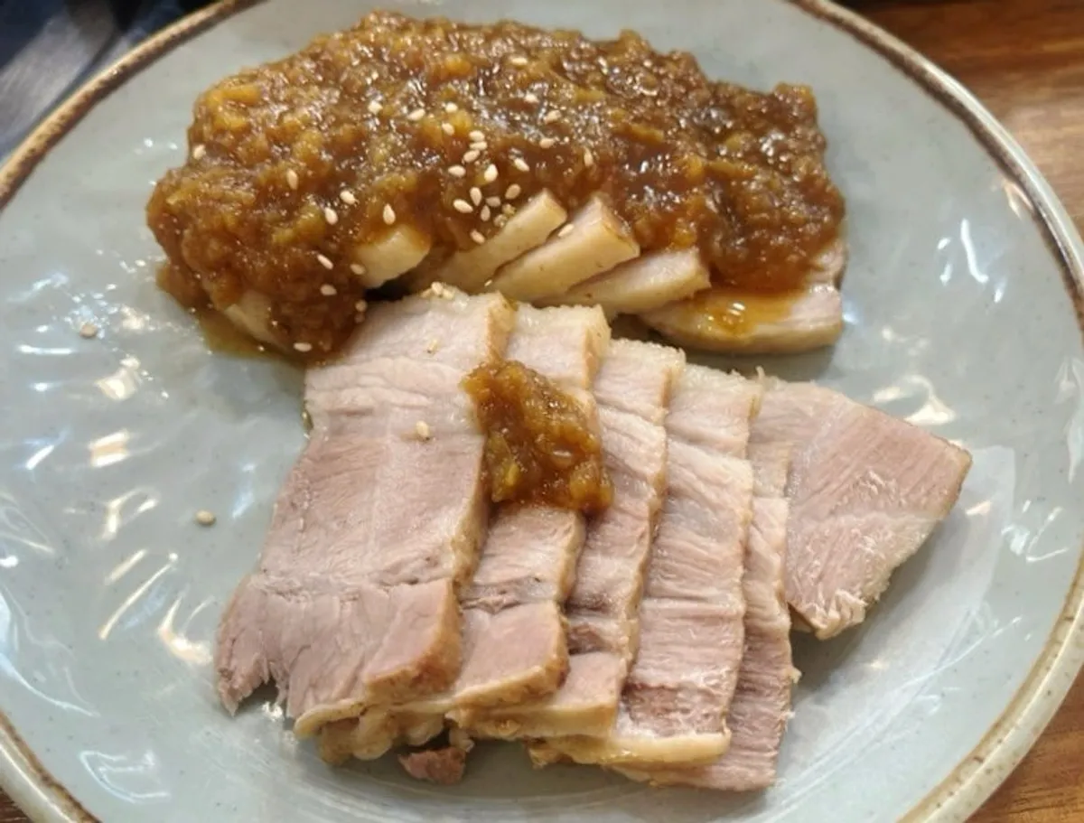 Bossam plate topped with black garlic sauce