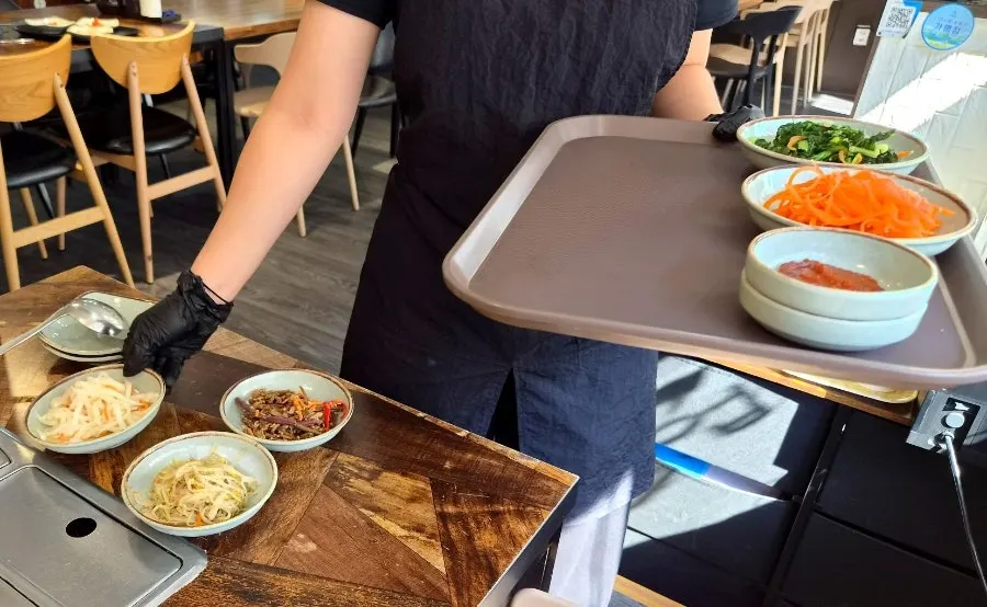 Side dishes being laid out on the table