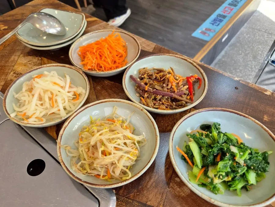 A full table spread of seasonal namul and side dishes