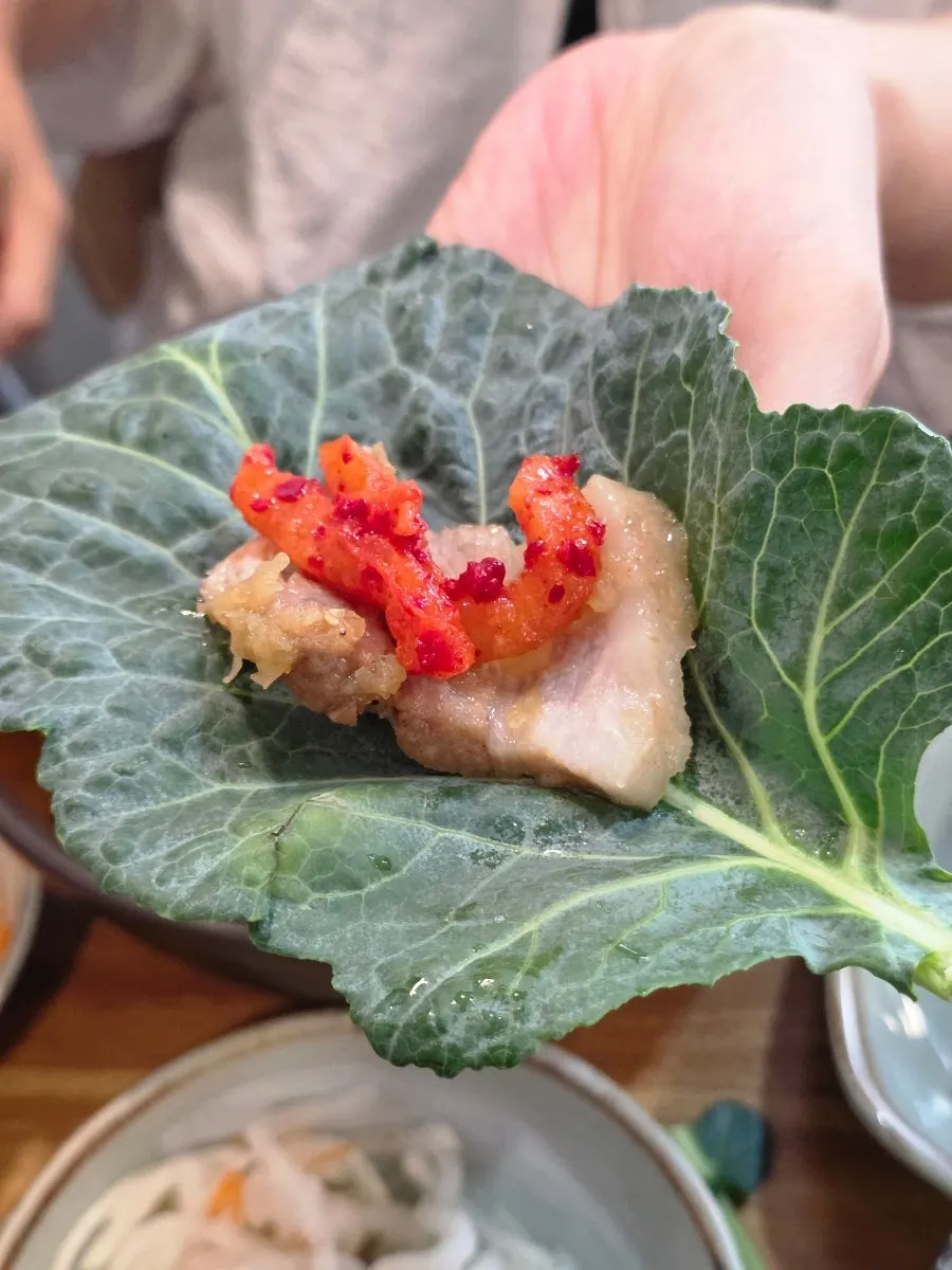 Lettuce wrap topped with black garlic sauce and ssamjang