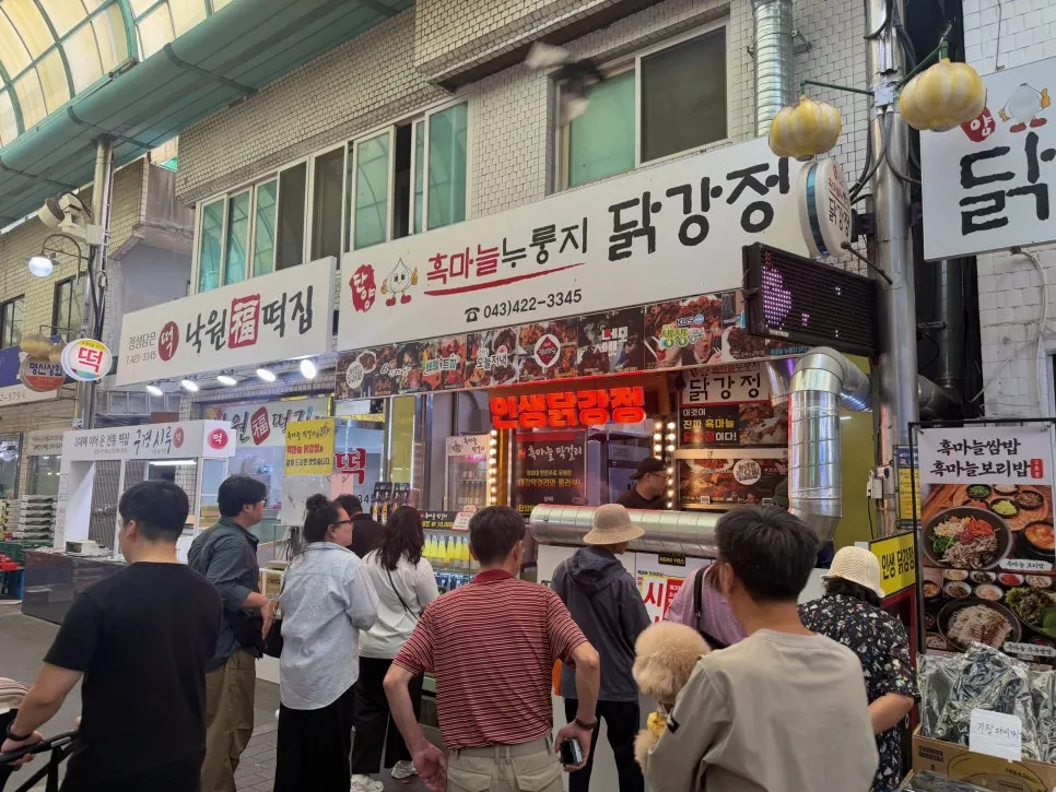 Customers waiting to order in front of the chicken stall