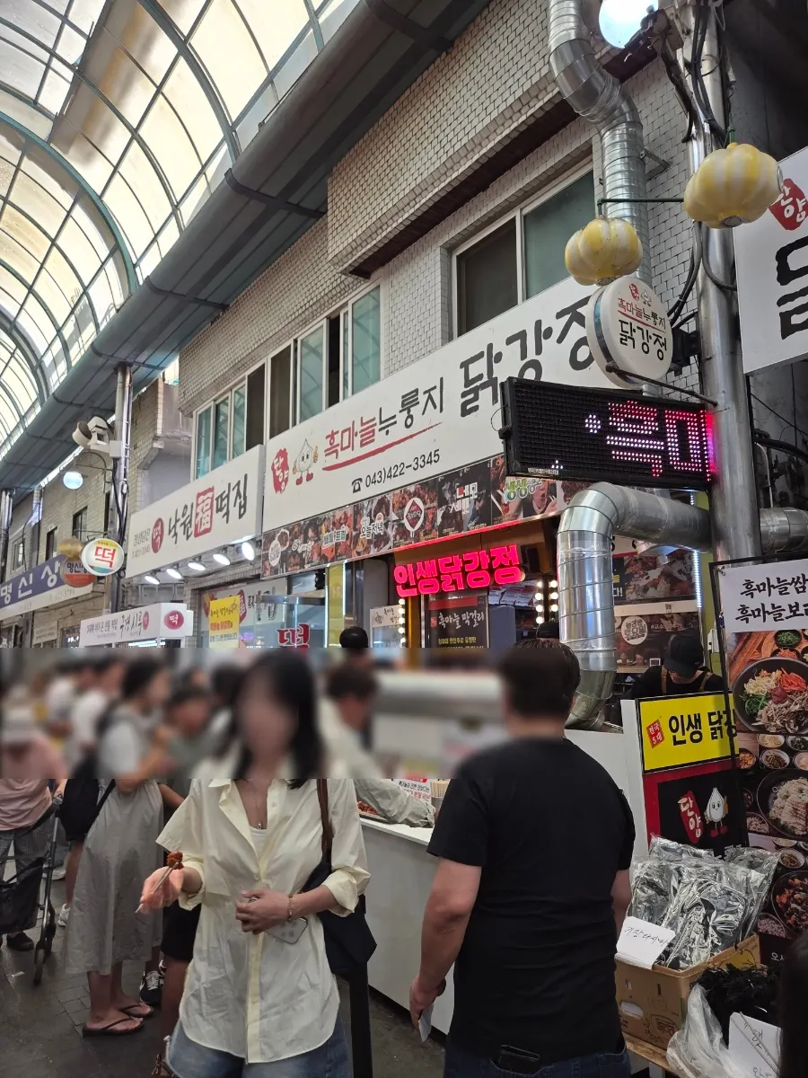 Crowd of customers in front of the dakgangjeong shop at Guyeong Market